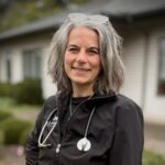 female veterinarian with short gray hair wearing a stethoscope